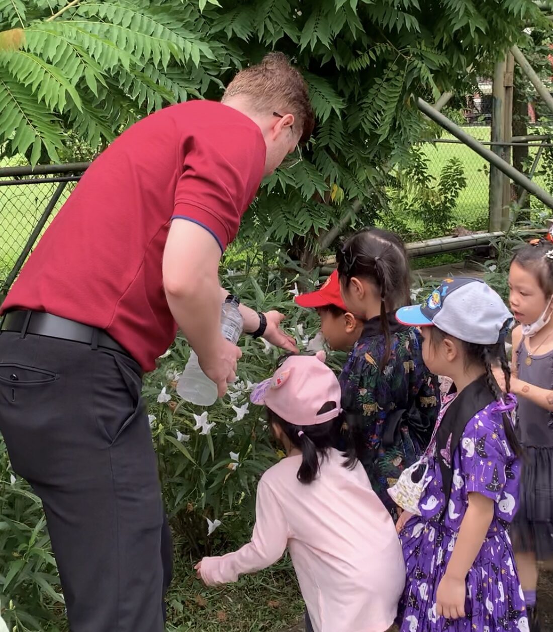 Native English teacher exploring organic farm with Kindergarten students at Ek Burapa School — Sustainability learning EP school Bangkok
