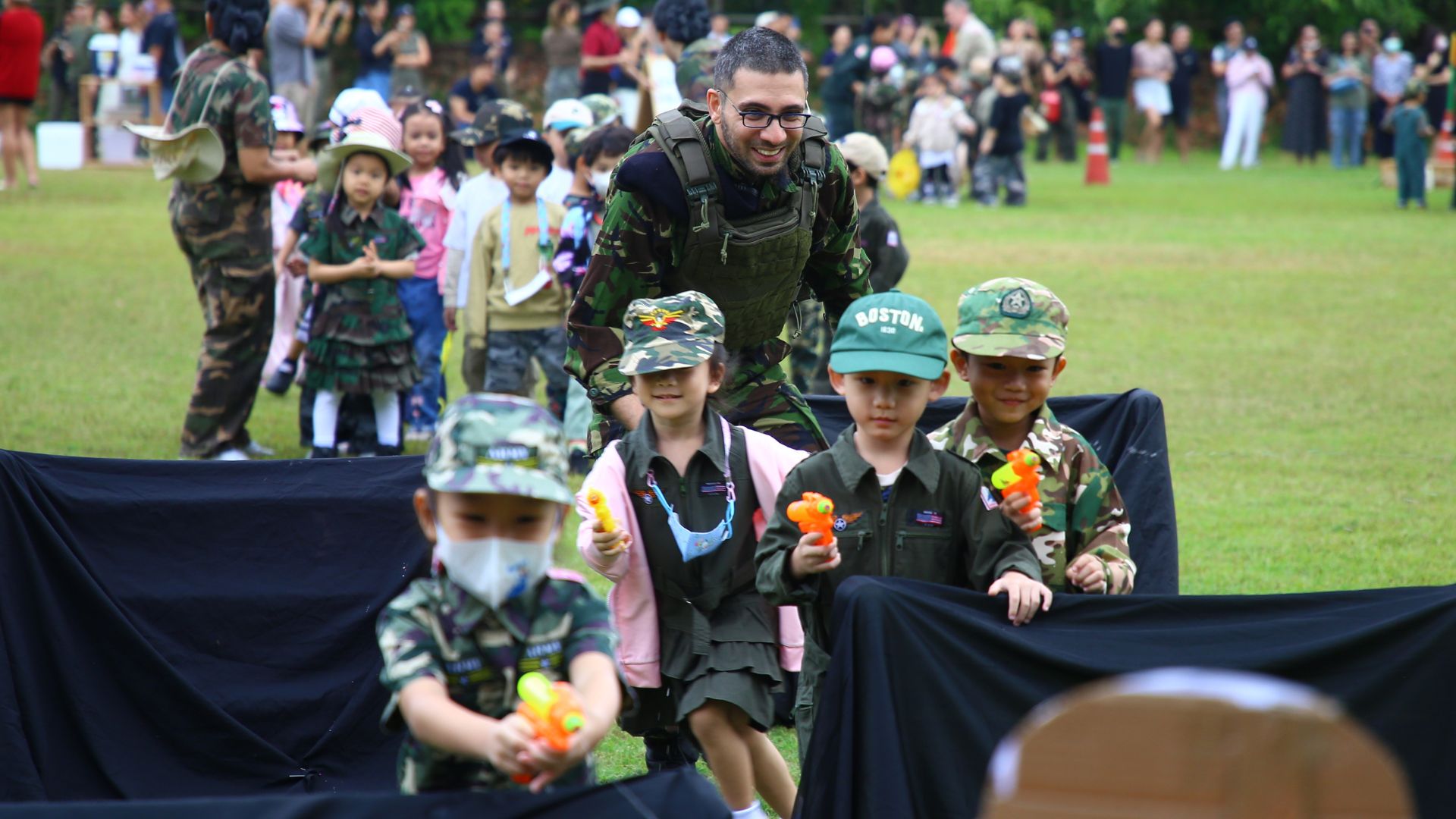 Kindergarten students in outdoor roleplay with native English teacher at Ek Burapa School — Joy of Learning EP school Minburi