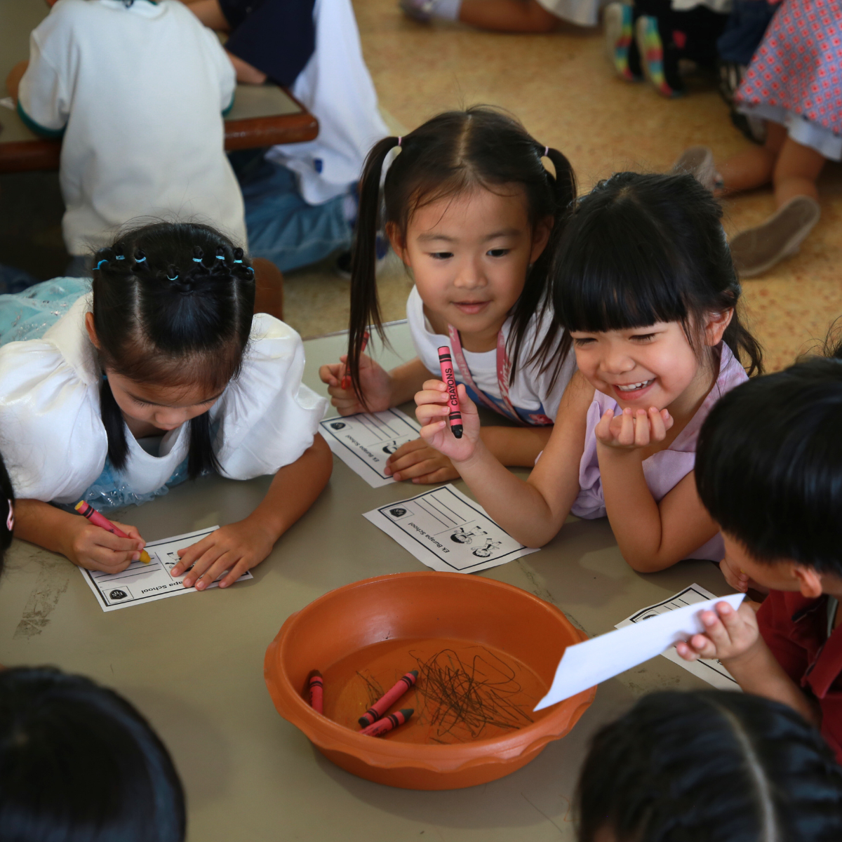 Kindergarten students in hands-on nature activity at Ek Burapa School — social awareness Sustainability play-based learning OIC EP school
