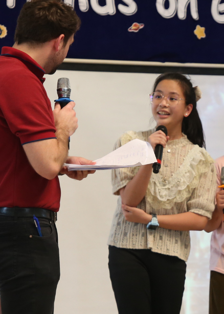 Primary student speaking on stage at Ek Burapa School — leadership development OIC EP school Bangkok Minburi